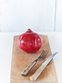 A pomegranate on a wooden board