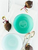 Soup bowls, spoons and beetroot