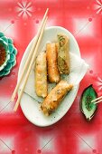 Spring rolls with various fillings on an oval platter