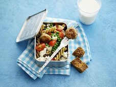 Pasta salad with vegetables and falafel in a lunchbox