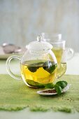 Tea made from aniseed and basil in a glass teapot