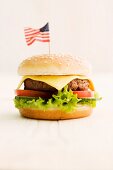 A cheeseburger decorated with an American flag