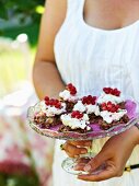 Chocolate crispy cakes topped with cream and redcurrants