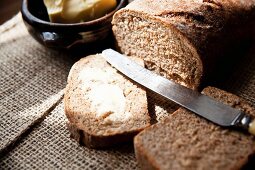 Freshly baked wholemeal bread with salted butter