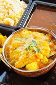Navratan korma with curried potatoes, rice and lentils