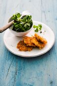 Pumpkin and corn cakes with lamb's lettuce