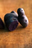 Purple potatoes on a wooden surface