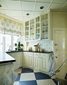 Antique, white, country-house kitchen with diagonal chequered floor