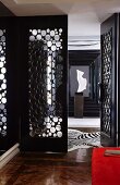 Open perforated door and zebra-skin rug in elegant entrance area