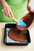 Brownie mix being poured into a baking tray