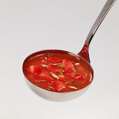 Tomato soup with thyme in a ladle