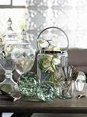Tischdekoration mit eleganten Glasgefäßen im Landhausstil und weißer Deko Orchideenblüte im Sektkühler