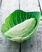 A wedge of white cabbage in a white cabbage leaf