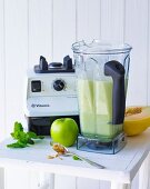 A smoothie made with cucumber, melon and apple being made in a mixer