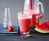 A smoothie made with melon, strawberries and alcohol free bitters