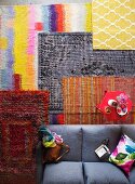 Colourful rugs in living room with red coffee table and grey sofa