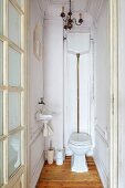 Vintage toilet with exposed, surface-mounted cistern in period apartment