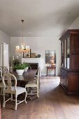 Elegant dining room with antique, country-house-style furniture and chandelier