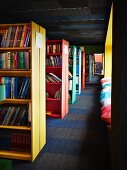 Free-standing colourful bookcases in library