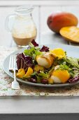 Mozzarella wrapped in mango on a radicchio salad with a curry and coconut dressing
