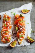 Baguette topped with smoked salmon and passion fruit