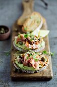 Rye bread topped with avocado cream and smoked salmon