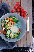 Chickpea salad with tomatoes, cucumber and garlic dressing