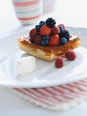A berry tartlet with whipped cream