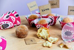 Doughnut balls in colourful paper cases with little name flags