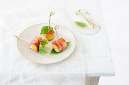 Potato and scallop canapés wrapped in bacon