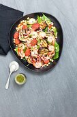 Grilled aubergine salad with spinach, chorizo and king prawns