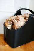 Schwarze Ledertasche mit Holzscheiten