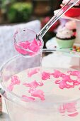 Pink plastic flamingo ice cubes in punch bowl