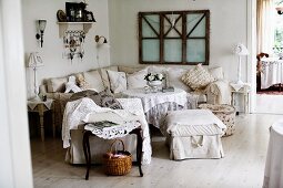 Lounge area with armchairs, ottomans and corner sofa around coffee table in rustic interior