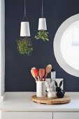 Upside-down planters (Sky Planter) above cooking utensils on kitchen worksurface