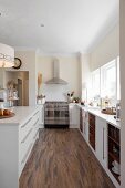 Open-plan kitchen with island counter and long counter below windows