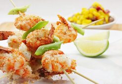 Crispy fried crayfish skewers with lime and grated coconut