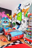 A children's room with a bright graffiti mural on the wall and a racing car bed