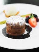 Chocolate soufflé with icing sugar and chocolate sauce