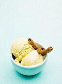 A bowl of homemade toffee ice cream with wafer rolls