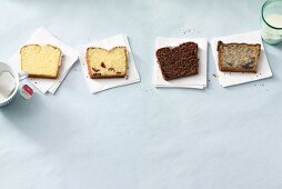 Four different slices of Madeira cake on napkins