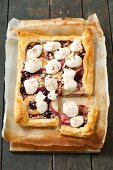 A puff pastry tart with almond cream, nectarines, cherries and meringue