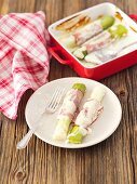Baked leek wrapped in ham with sour cream and Parmesan