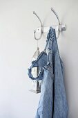 Denim dress with ruffled straps and Oriental lantern hanging from simple, metal coat hooks