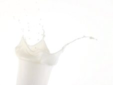 Milk splashing out of glass