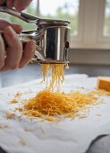Grating Cheddar cheese