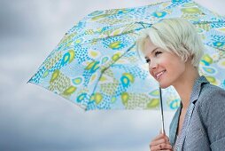 Blonde woman holding umbrella