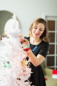 Young woman holding Christmas ornament