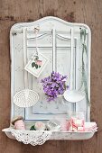 Various utensils, ladles and campanula on white enamel spoon rack