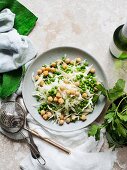 A plate of salad with white cabbage and peas